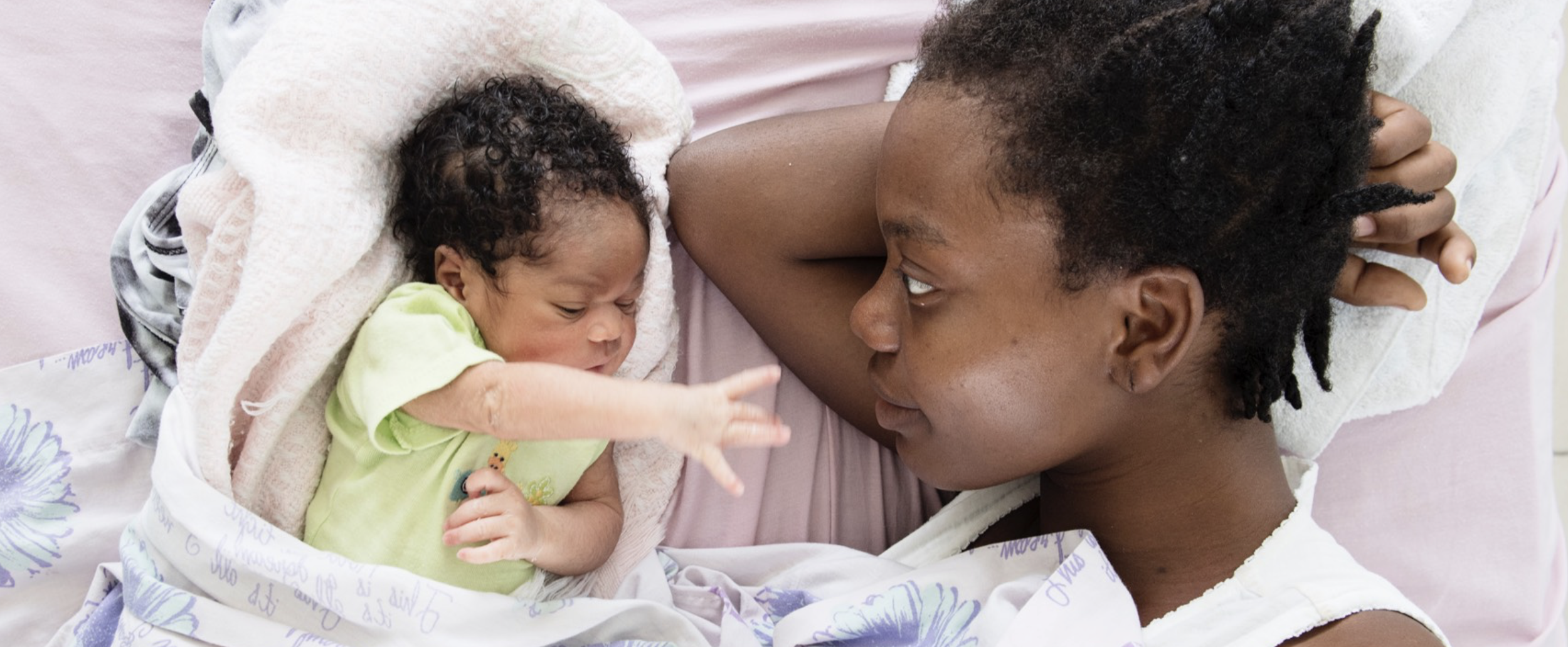 newborn and mom looking at each other